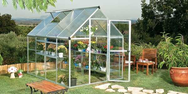 A canopia hybrid silver greenhouse in a garden.
